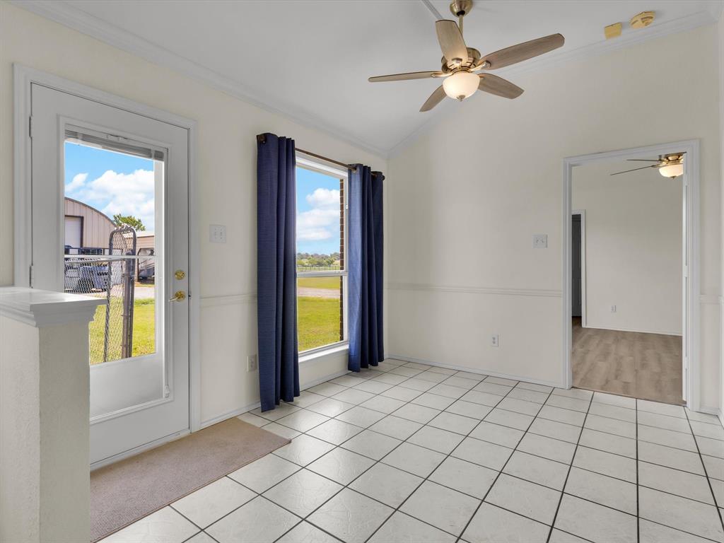 10832 Sky Ridge Court Haslet, TX 76052 - Photo 15 of 40 a view of an empty room and window with a kitchen