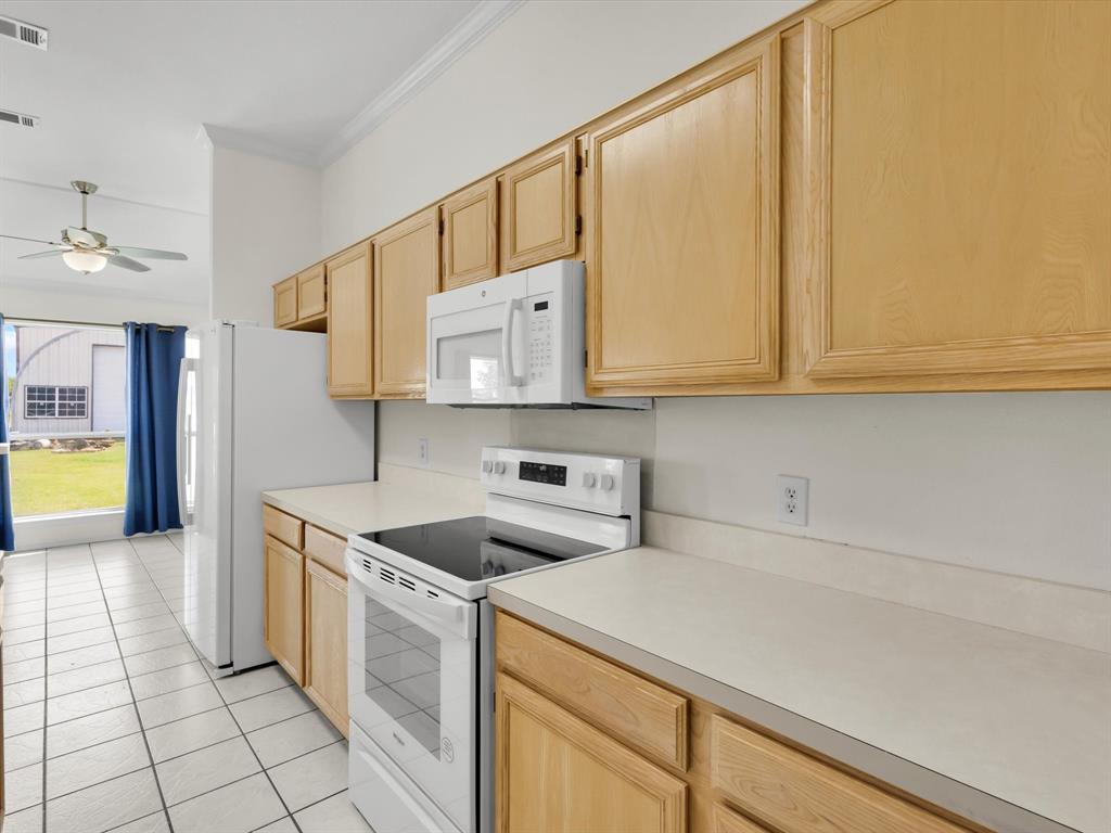 10832 Sky Ridge Court Haslet, TX 76052 - Photo 18 of 40 a kitchen with a sink cabinets and appliances