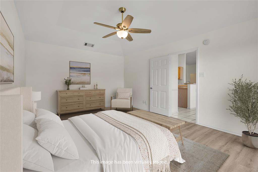 10832 Sky Ridge Court Haslet, TX 76052 - Photo 22 of 40 a bedroom with a bed and a chandelier