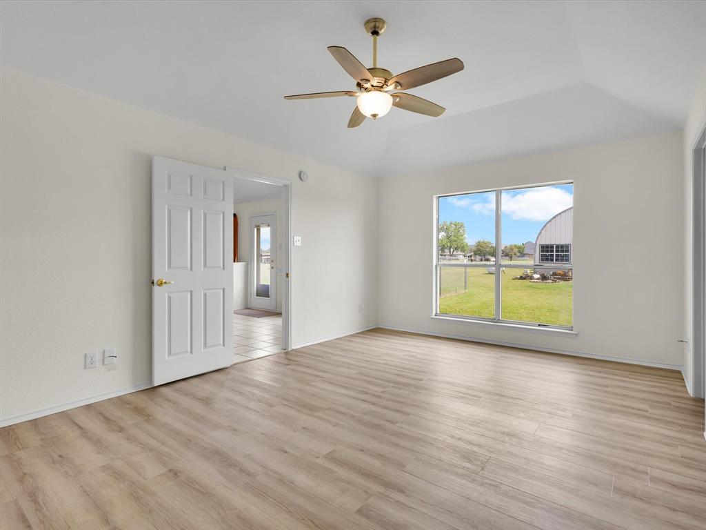 10832 Sky Ridge Court Haslet, TX 76052 - Photo 25 of 40 a view of an empty room with a window and wooden floor