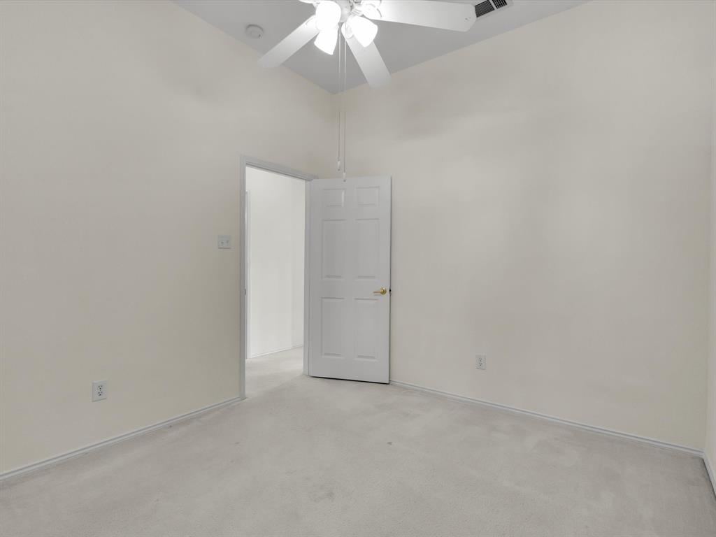 10832 Sky Ridge Court Haslet, TX 76052 - Photo 29 of 40 an empty room with a ceiling fan and a window