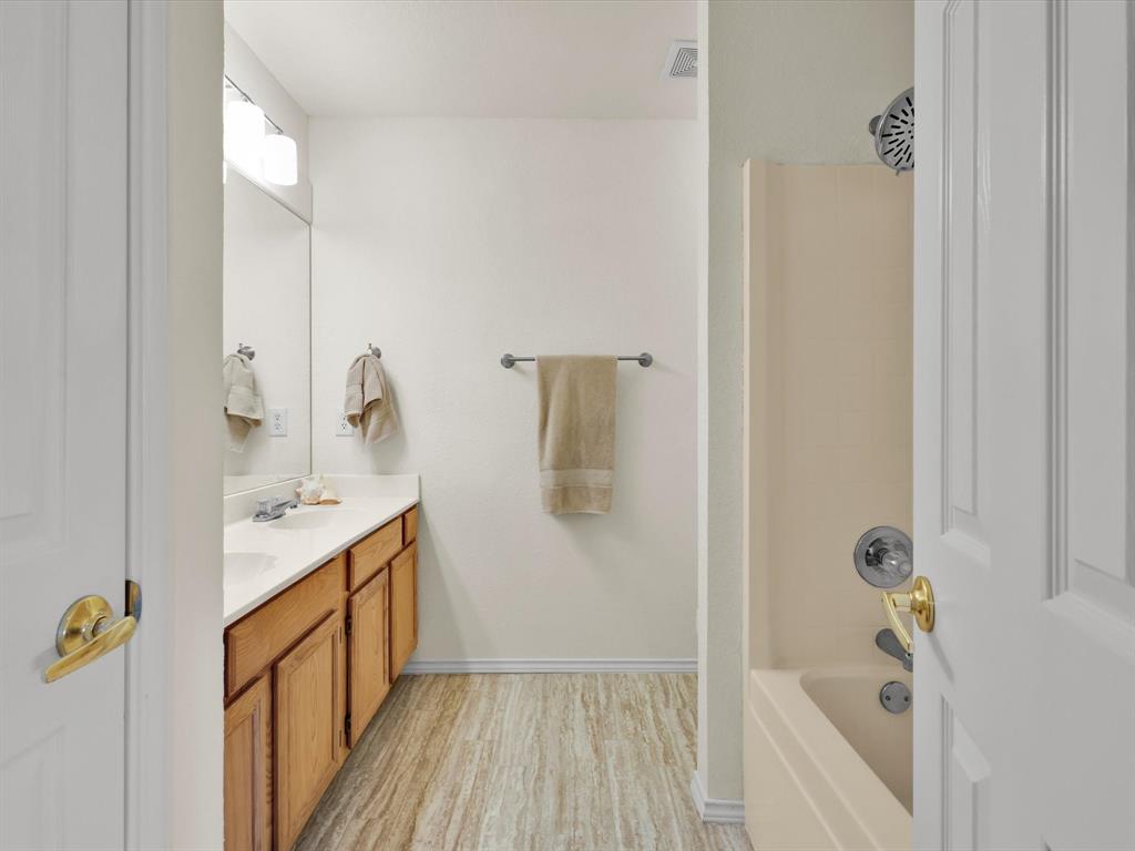 10832 Sky Ridge Court Haslet, TX 76052 - Photo 30 of 40 a bathroom with a sink and shower