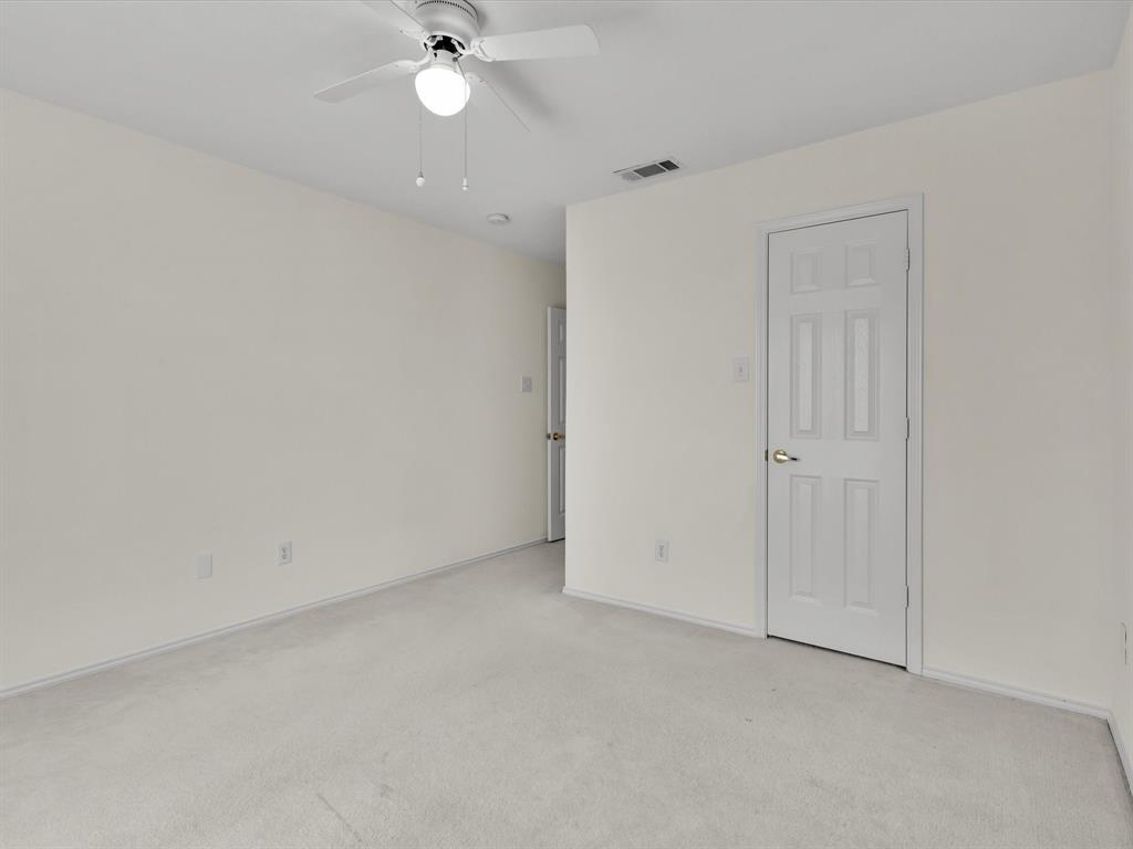 10832 Sky Ridge Court Haslet, TX 76052 - Photo 36 of 40 an empty room with closet and a chandelier fan
