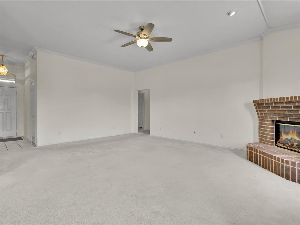 10832 Sky Ridge Court Haslet, TX 76052 - Photo 9 of 40 a view of an empty room with a fireplace