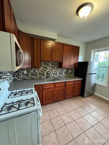a kitchen with stainless steel appliances a stove a sink and a microwave