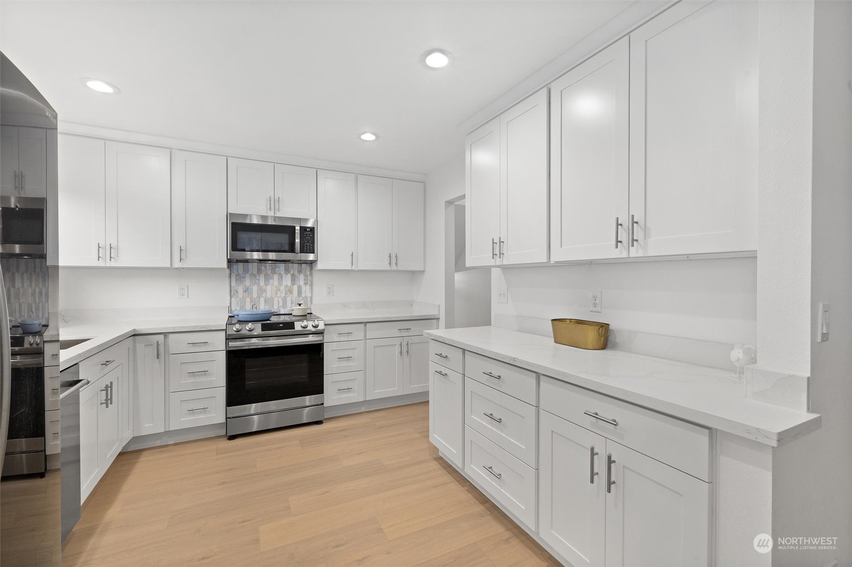 513 211th Place Southeast Bothell, WA 98021 - Photo 15 of 39 a kitchen with granite countertop white cabinets and stainless steel appliances