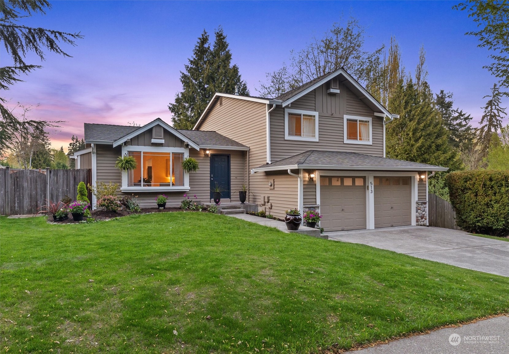 513 211th Place Southeast Bothell, WA 98021 - Photo 3 of 39 a front view of a house with a garden