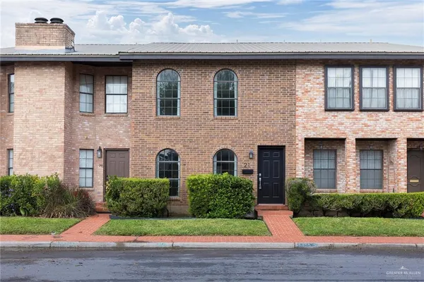 a brick building with a yard in front of it