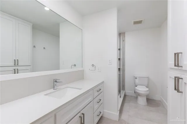 a bathroom with a shower and toilet
