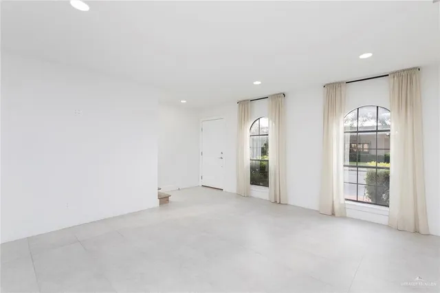 a kitchen with stainless steel appliances a sink a stove a refrigerator cabinets a sink and a stove