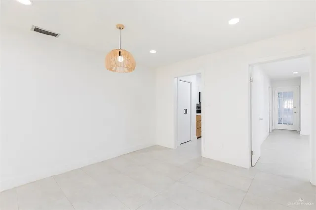 an empty room with mirror in closet