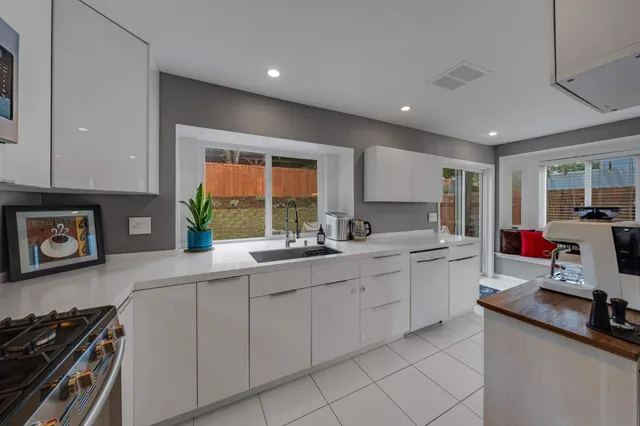 a kitchen with sink attached with living room