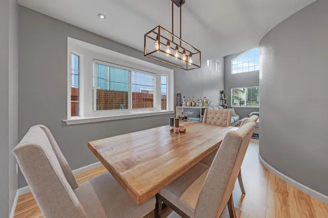 a dining room with furniture a chandelier and window