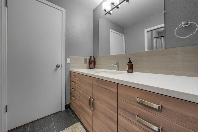 a bathroom with a sink double vanity and a mirror
