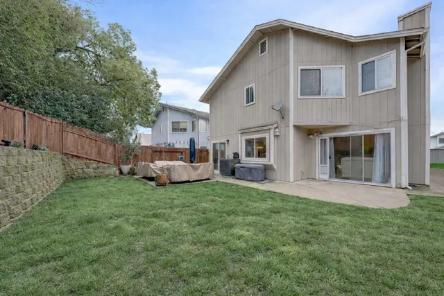 a view of a house with a yard and sitting area