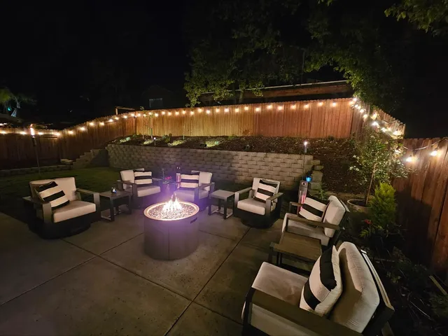 a view of a patio with table and chairs and potted plants