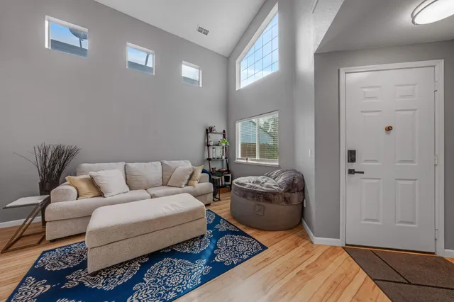 a bedroom with a bed couch and a window