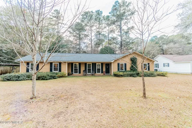 a front view of a house with a yard covered in snow