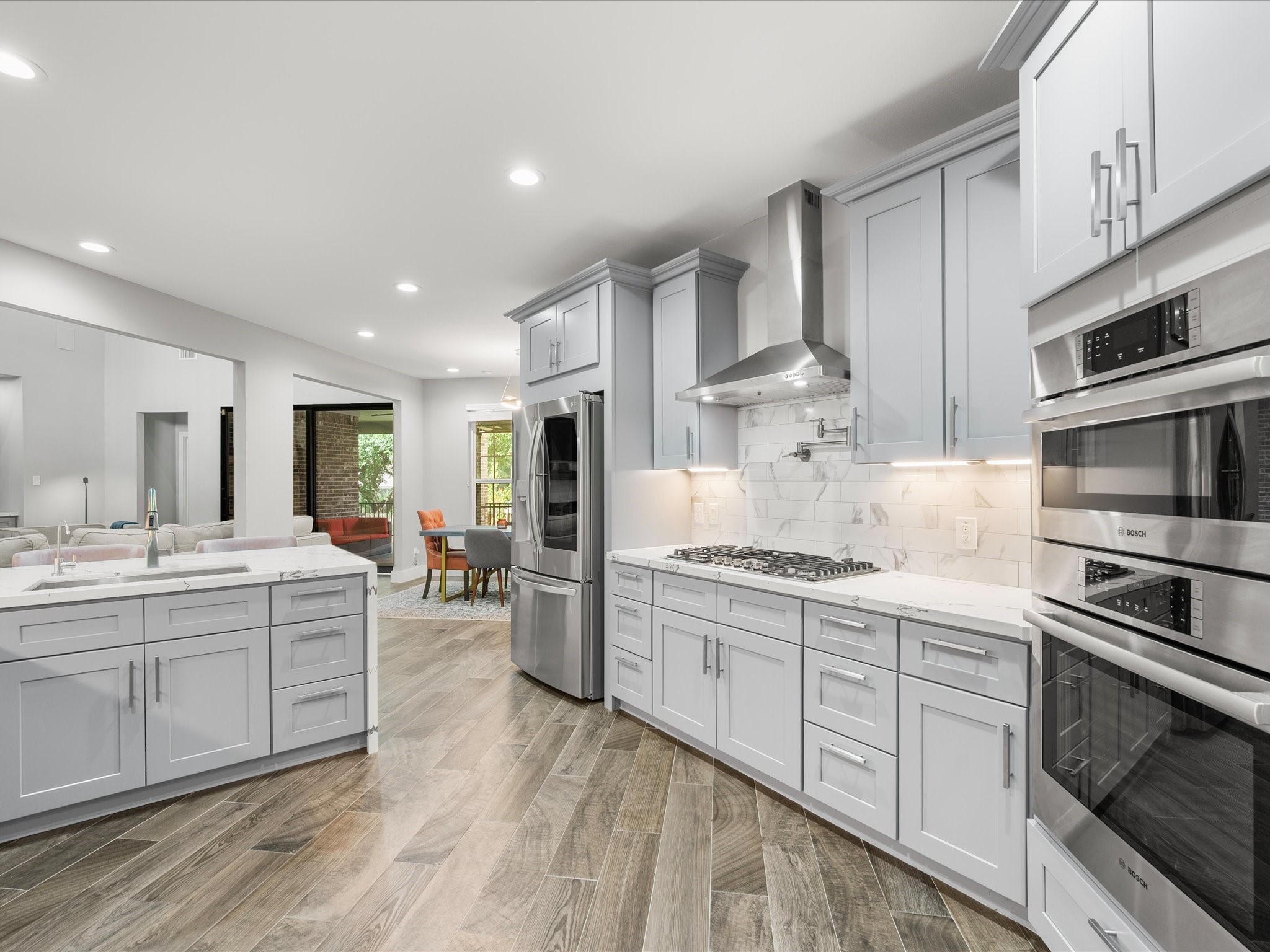 6207 Graff Net Court Spring, TX 77379 - Photo 18 of 48 A gas cooktop with pot filler, stainless steel appliances, and modern cabinetry including dedicated pot and pan drawers make this kitchen as practical as it is beautiful.