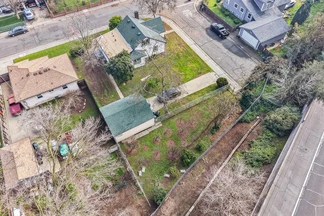 a view of a house with yard and a tree