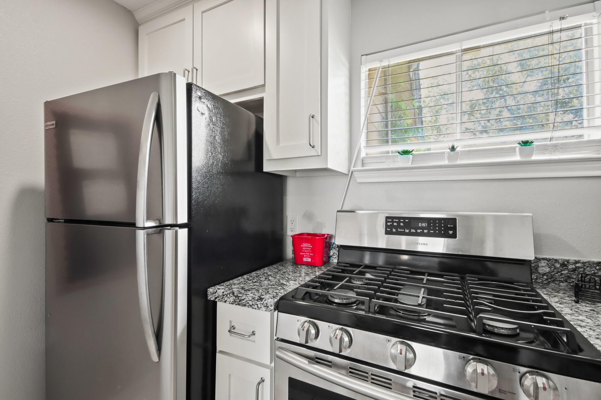 5302 Treaschwig Road Spring, TX 77373 - Photo 32 of 50 a kitchen with stainless steel appliances granite countertop a refrigerator and a stove