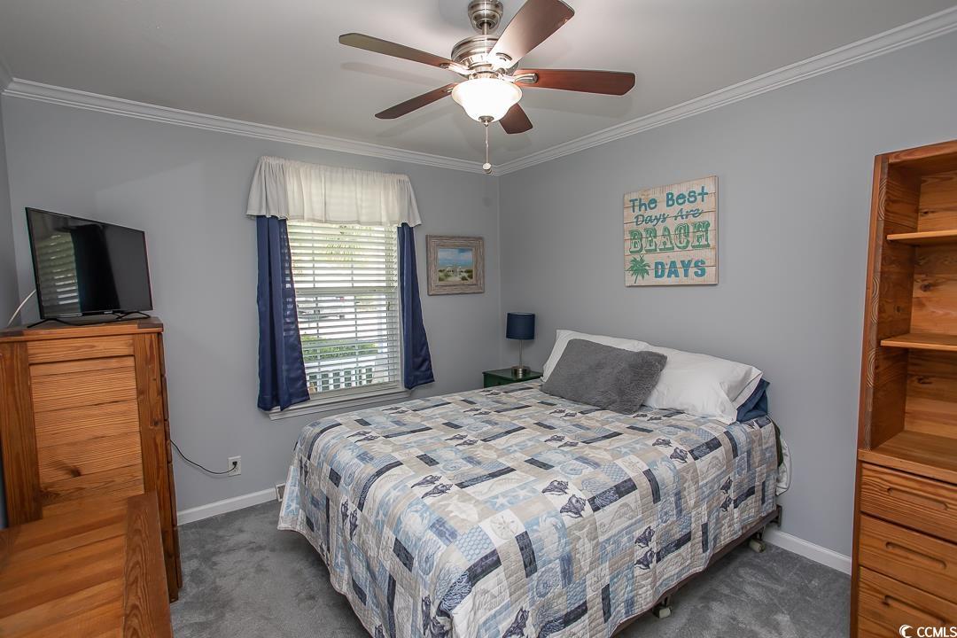 318 Walden Lake Road Conway, SC 29526 - Photo 20 of 33 Bedroom with ceiling fan, dark carpet, and ornamen