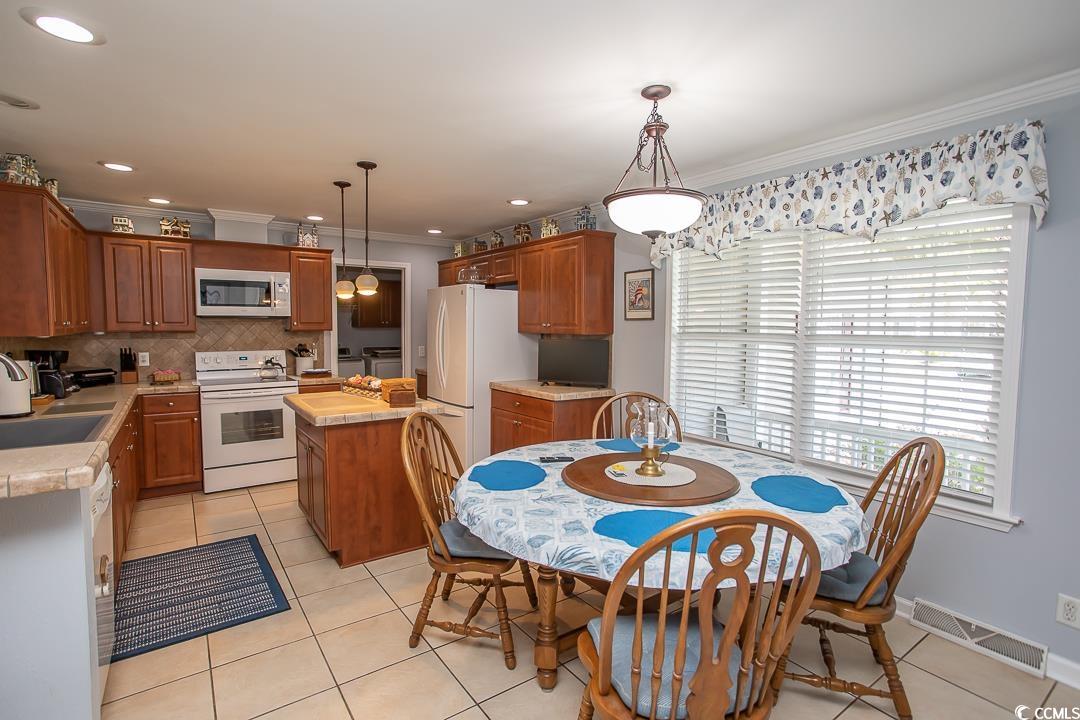 318 Walden Lake Road Conway, SC 29526 - Photo 3 of 33 Tiled dining room with sink and crown molding