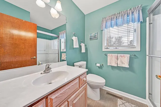 a bathroom with a sink a toilet and mirror