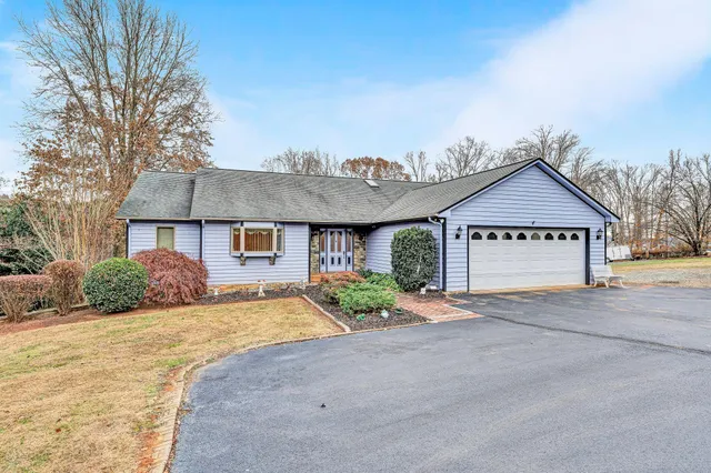 a view of large house with a big yard and large tree