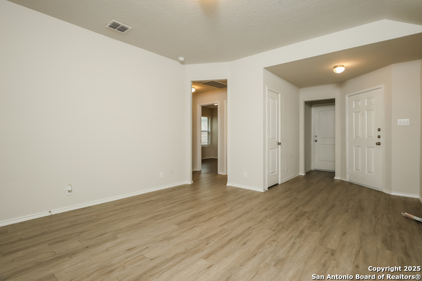 5227 Blue Ranch San Antonio, TX 78222 - Photo 5 of 17 an empty room with wooden floor and closet