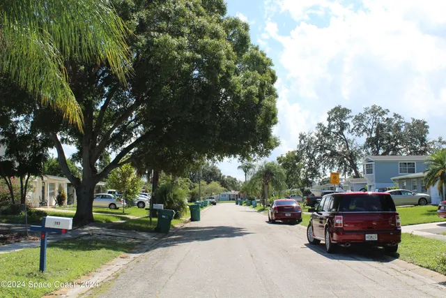 a view of a street with cars on road