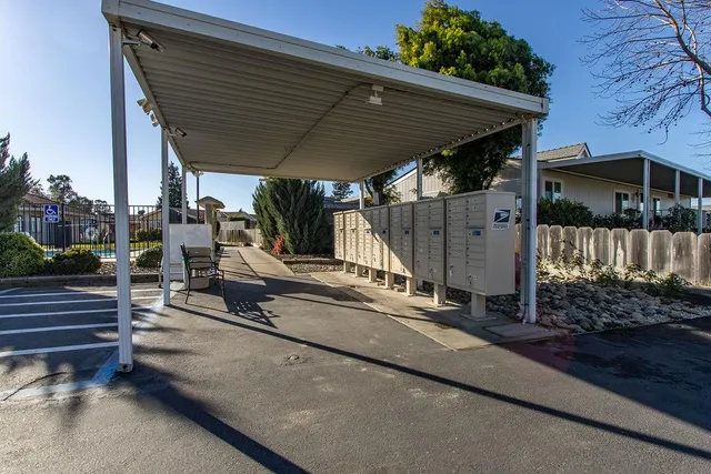 a view of a house with backyard and sitting area