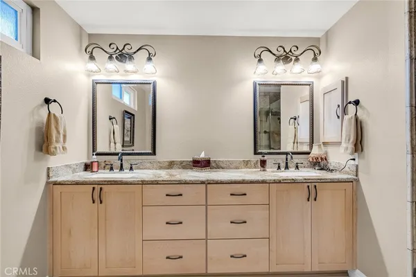 a bathroom with a double vanity sink and a mirror