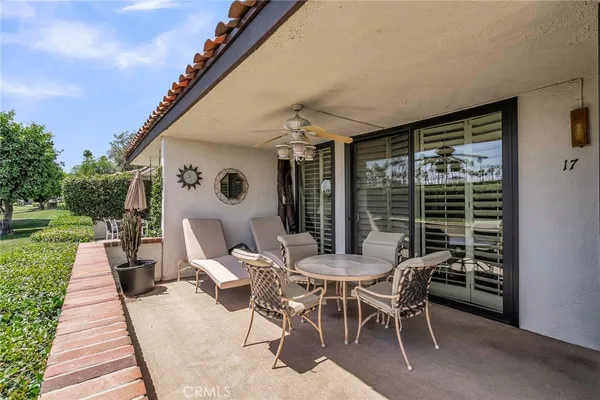 a dining room with furniture and garden view