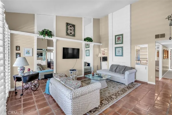 a living room with furniture a flat screen tv and a table