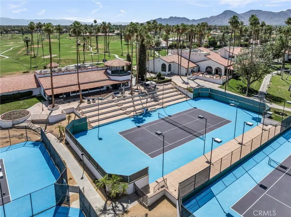 a view of a swimming pool with outdoor seating and lake view