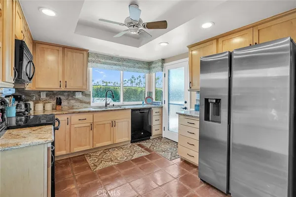 a kitchen with a refrigerator sink and cabinets