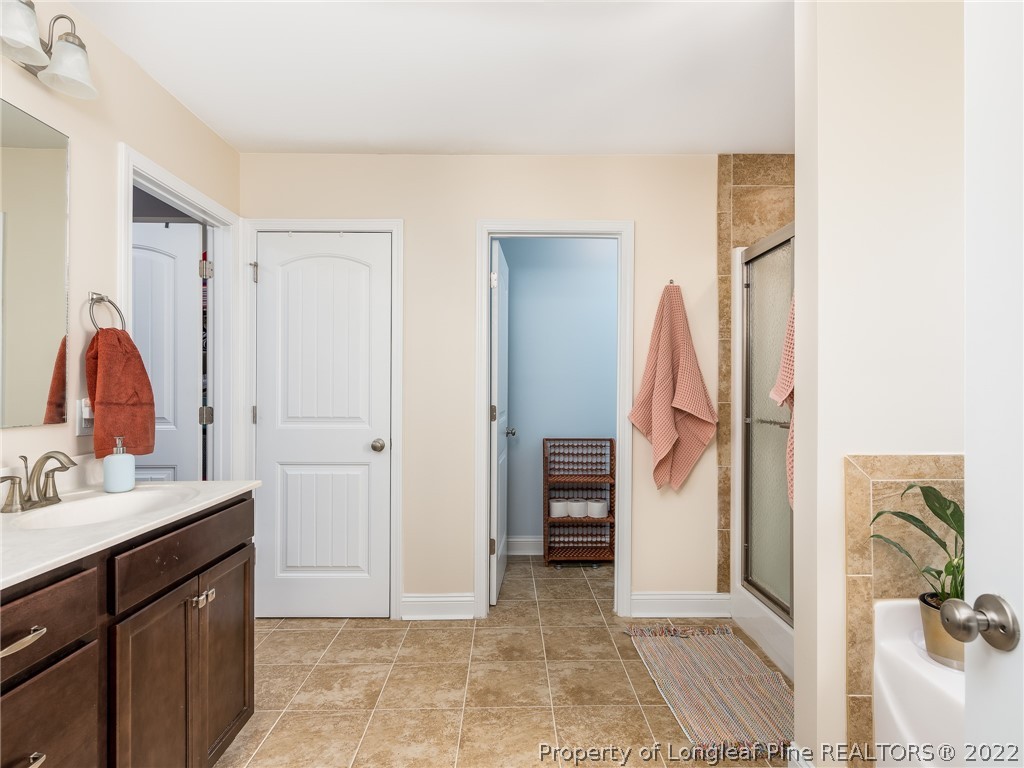 5137 Boxcut Lane Hope Mills, NC 28348 - Photo 29 of 48 a bathroom with a sink and a mirror