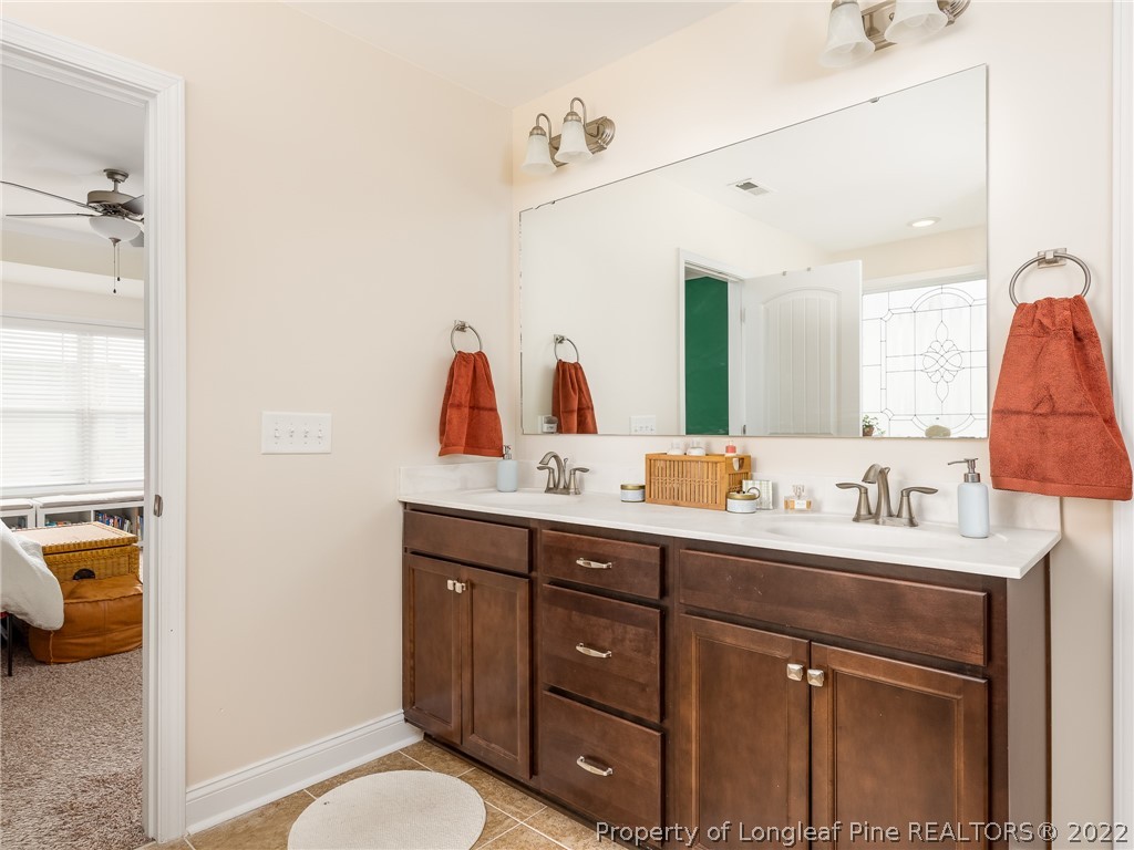 5137 Boxcut Lane Hope Mills, NC 28348 - Photo 30 of 48 a bathroom with a granite countertop sink vanity mirror bathtub and toilet