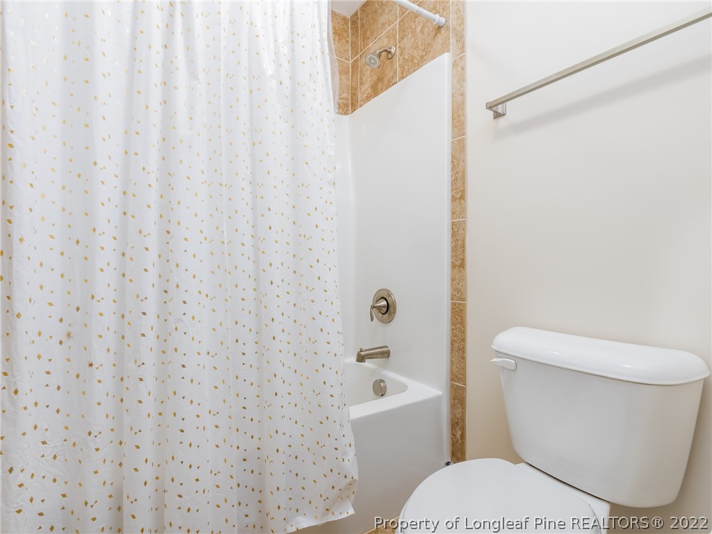 5137 Boxcut Lane Hope Mills, NC 28348 - Photo 35 of 48 a white toilet sitting next to a bath tub