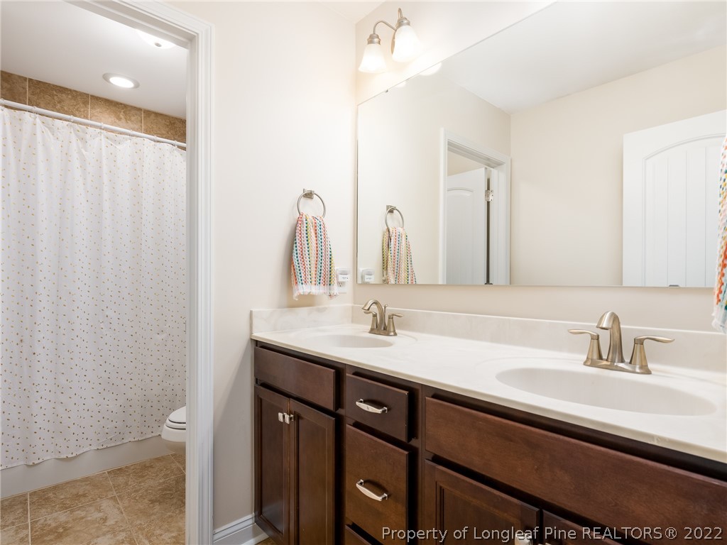 5137 Boxcut Lane Hope Mills, NC 28348 - Photo 36 of 48 a bathroom with a double vanity sink and a mirror