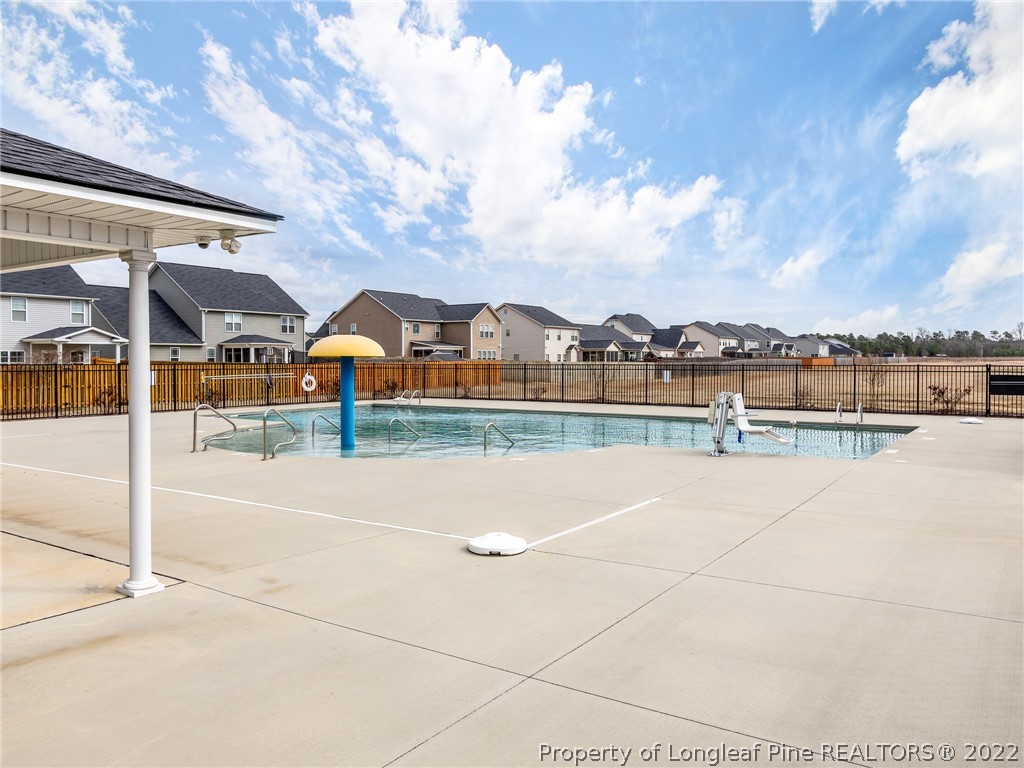 5137 Boxcut Lane Hope Mills, NC 28348 - Photo 48 of 48 a view of swimming pool with outdoor seating and buildings in the background