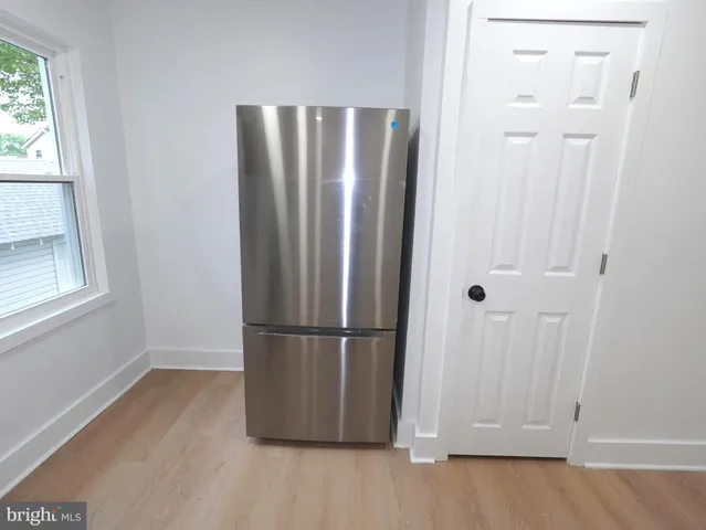 a view of a refrigerator in kitchen and wooden floor