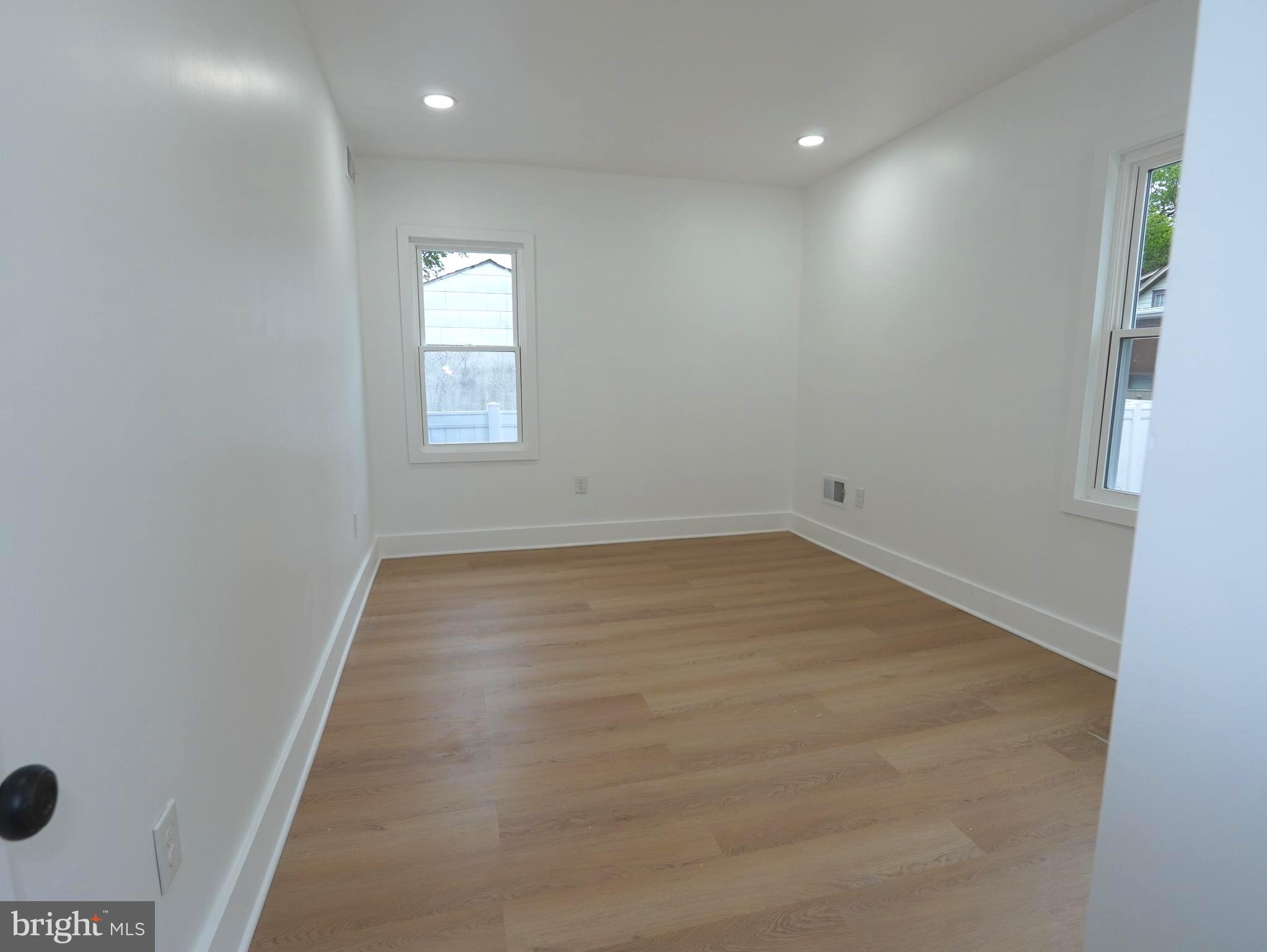 3200 Calvert Avenue, Unit C Haddon Township, NJ 08107 - Photo 5 of 8 an empty room with wooden floor and windows