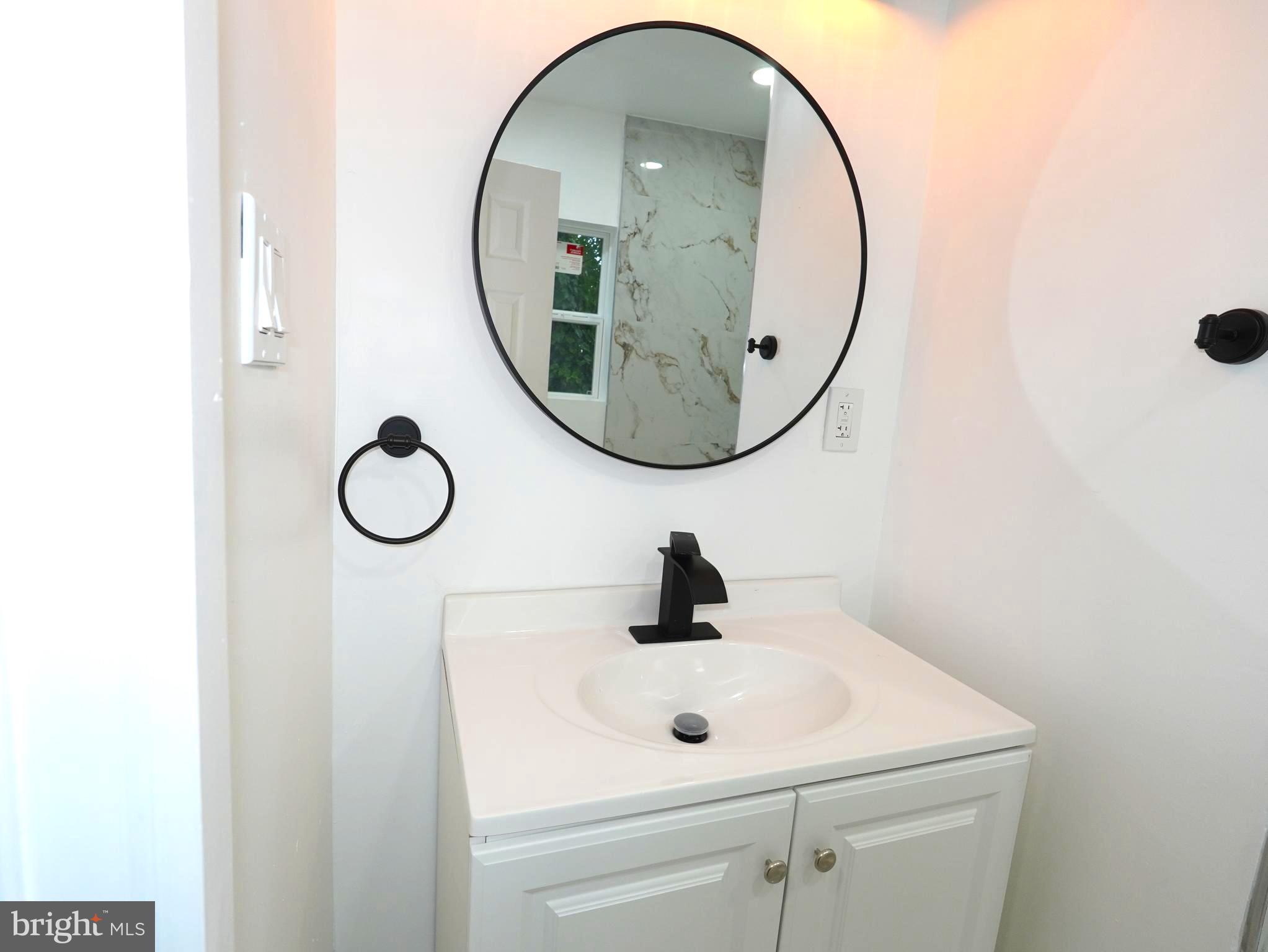 3200 Calvert Avenue, Unit C Haddon Township, NJ 08107 - Photo 6 of 8 a bathroom with a sink and a mirror