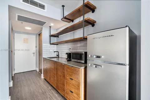 a kitchen with stainless steel appliances a refrigerator and a stove top oven