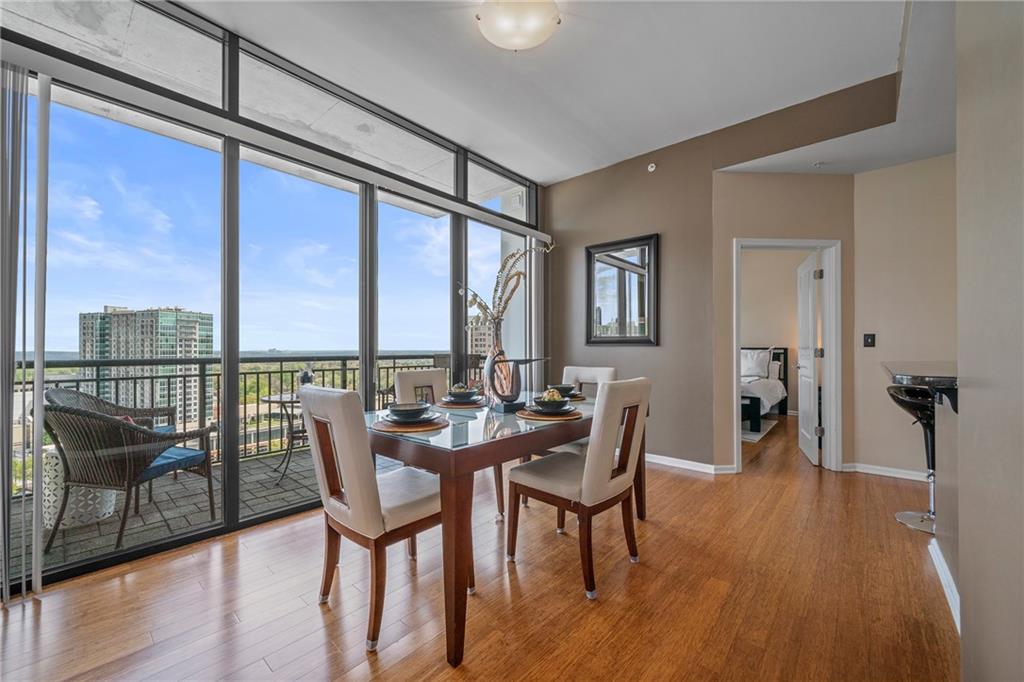 a dining room with furniture window and wooden floor