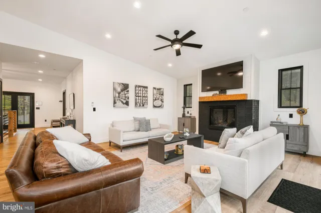 a living room with furniture a fireplace and a flat screen tv