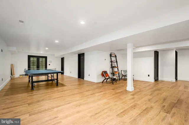 a view of a room with furniture and wooden floor