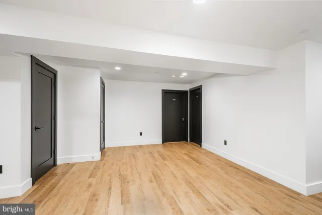 a view of a room with wooden floor and furniture